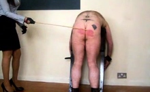 Miss Sultrybelle canes a willing sub.