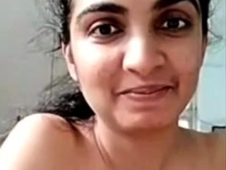 Horny busty indian milf strips nude to show round tits